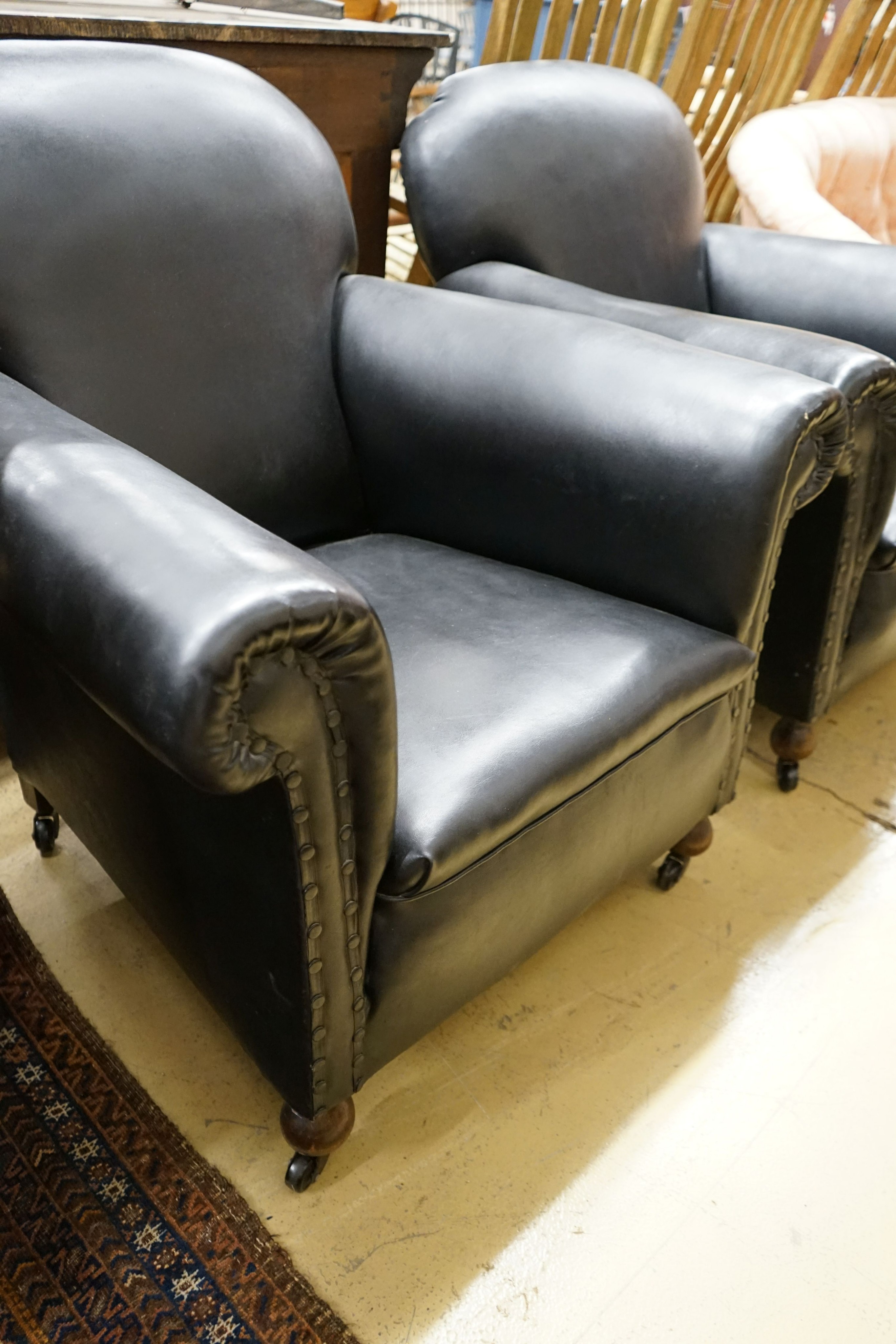 A pair of early 20th century club armchairs, width 88cm, depth 88cm, height 84cm